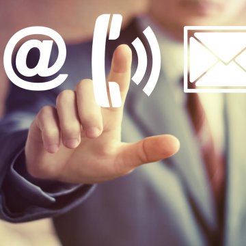 man in suit touching call phone sign voip services 1-voip business